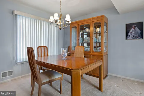 a view of a dining room with furniture window and chandelier