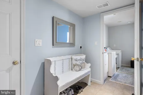 a living room with furniture and a baby crib