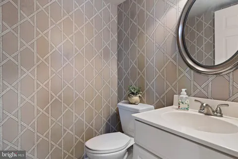 a bathroom with a toilet a sink and a mirror