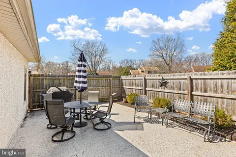 a view of a chairs and tables in the back yard of the house