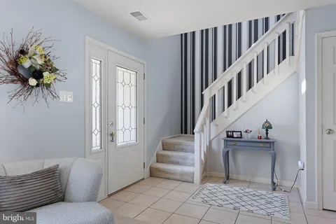 a living room with furniture and stairs