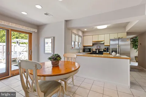 a dining room with furniture a window and appliances