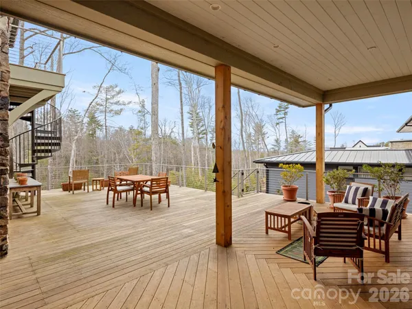 a view of a patio with dining table and chairs
