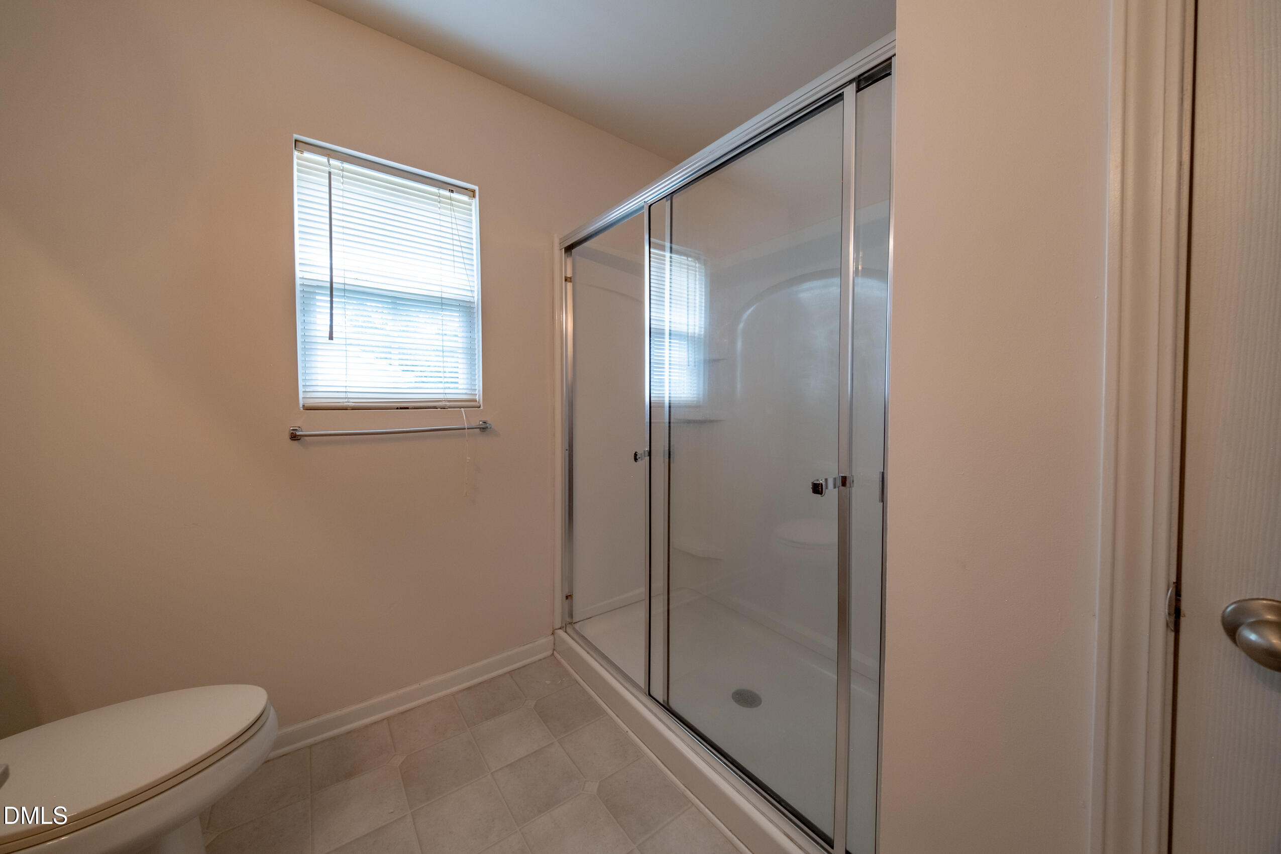 719 Obsidian Way Durham, NC 27703 - Photo 30 of 41 a bathroom with a granite countertop toilet and a shower
