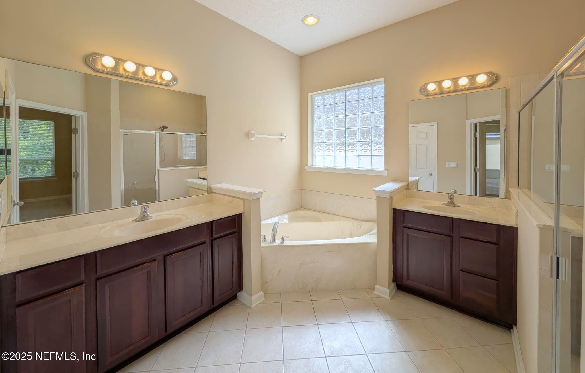 5871 Brush Hollow Road Jacksonville, FL 32258 - Photo 13 of 40 a spacious bathroom with a tub sink shower and mirror