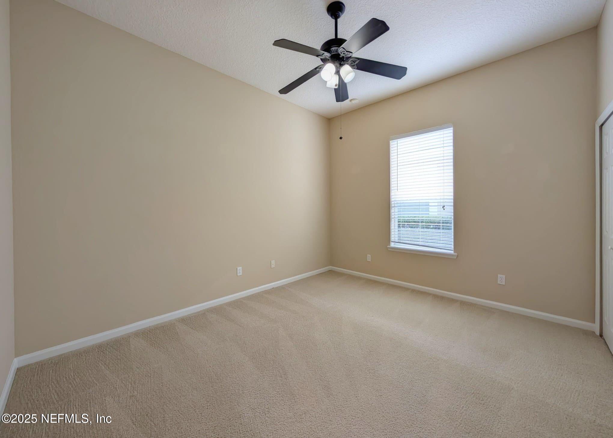 5871 Brush Hollow Road Jacksonville, FL 32258 - Photo 16 of 40 an empty room with a window and a fan