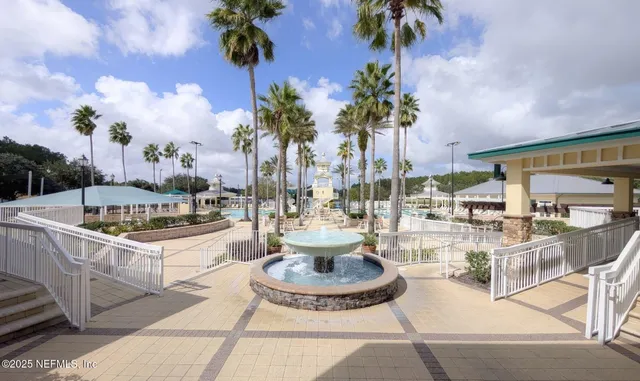 a view of a swimming pool with outdoor seating and plants