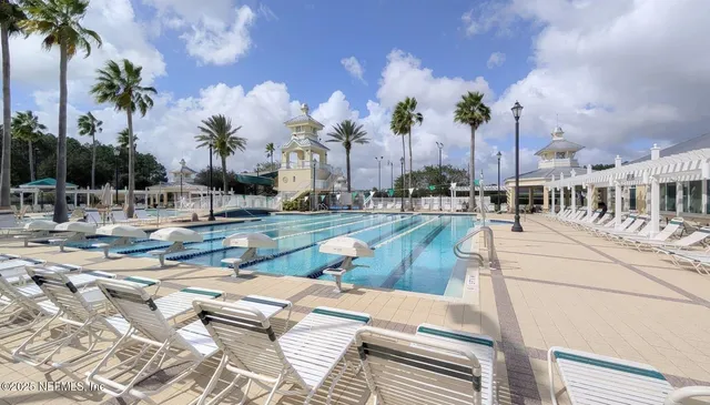 a view of a swimming pool with outdoor seating