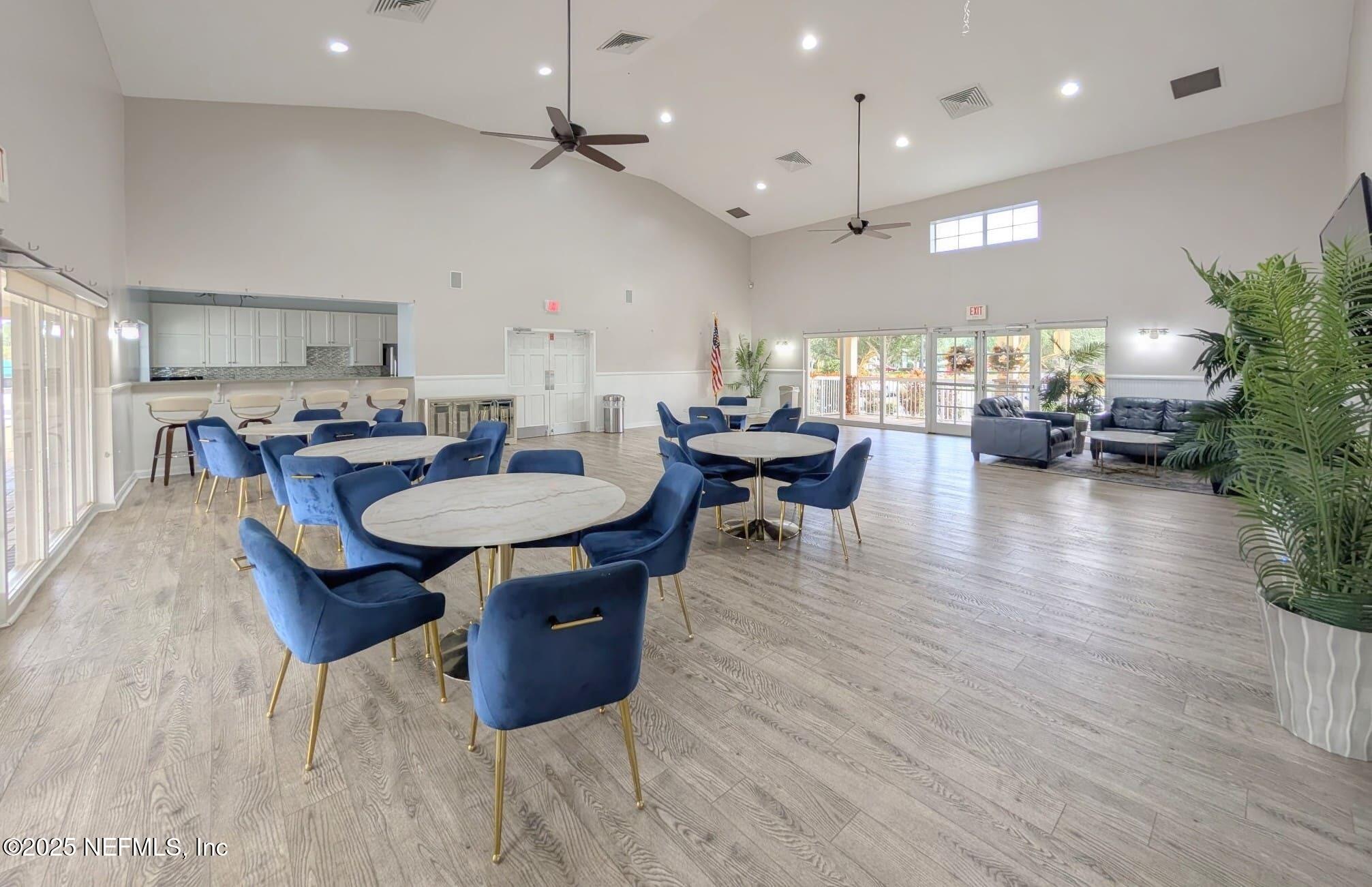 5871 Brush Hollow Road Jacksonville, FL 32258 - Photo 33 of 40 an open kitchen with granite countertop a stove a sink a dining table and chairs with wooden floor