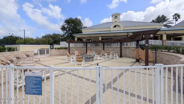 a view of a patio with table and chairs with wooden floor and fence
