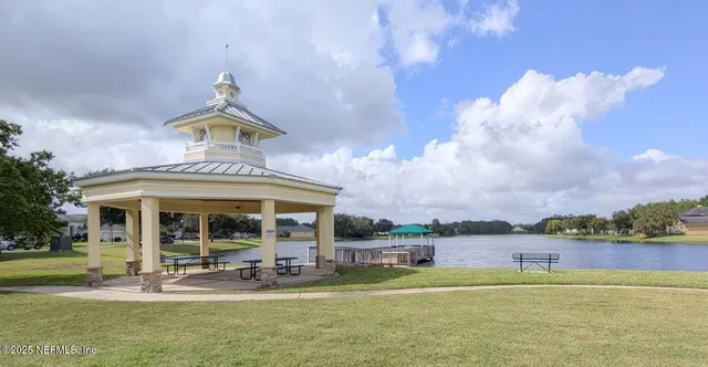 a view of a house with a yard balcony and sitting area