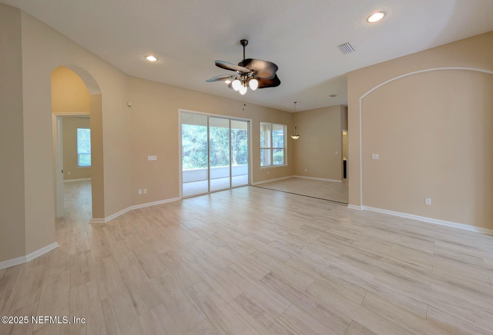 5871 Brush Hollow Road Jacksonville, FL 32258 - Photo 6 of 40 a view of an empty room with a window and wooden floor