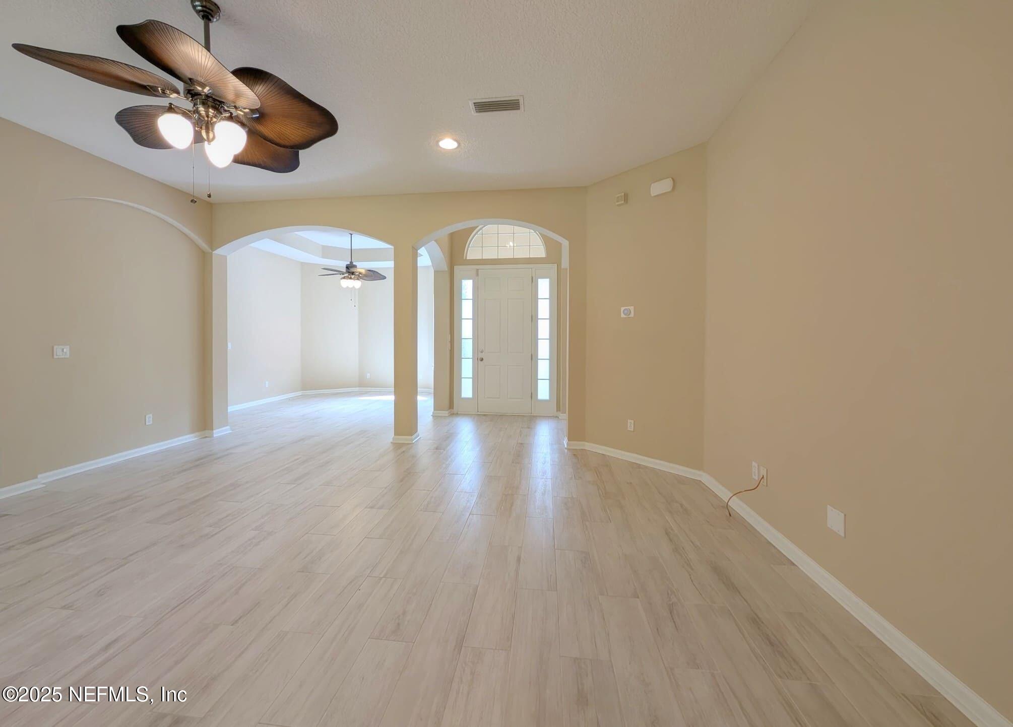 5871 Brush Hollow Road Jacksonville, FL 32258 - Photo 9 of 40 wooden floor in an empty room with a window