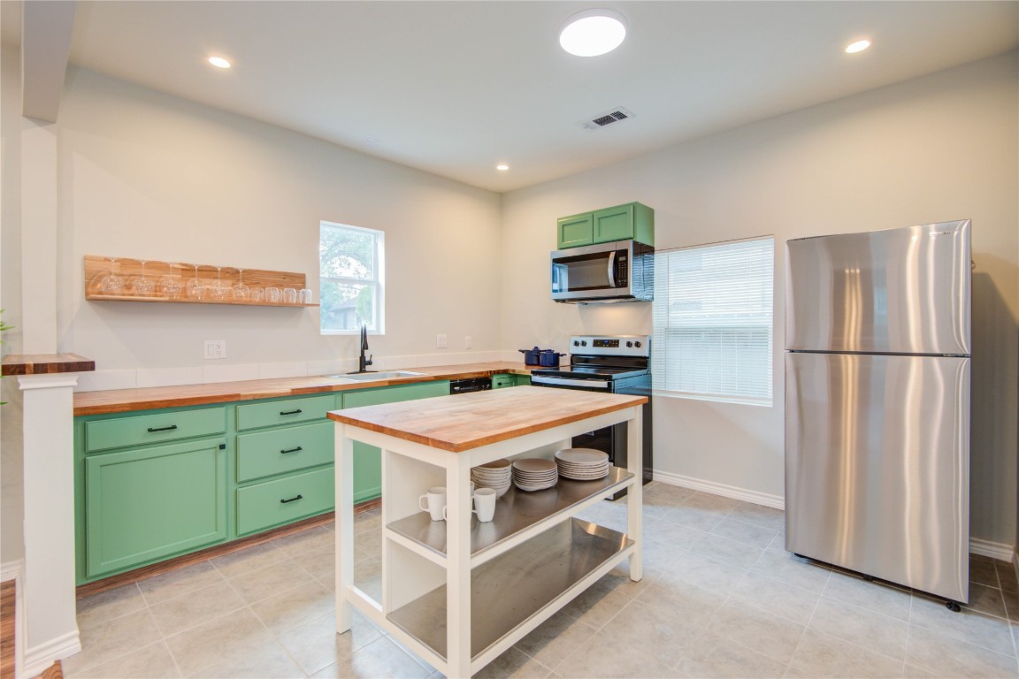 2712 Link Road Houston, TX 77009 - Photo 11 of 35 a kitchen with cabinets and stainless steel appliances