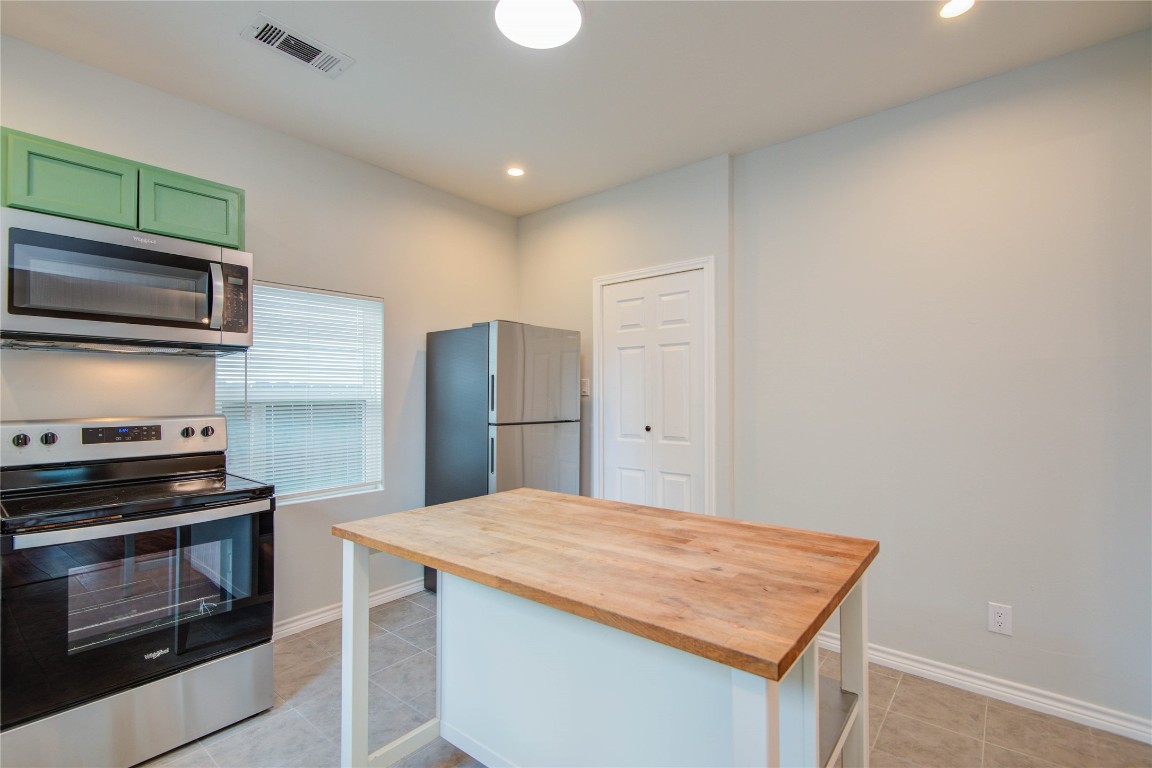 2712 Link Road Houston, TX 77009 - Photo 13 of 35 a kitchen with stainless steel appliances kitchen island a stove and a microwave