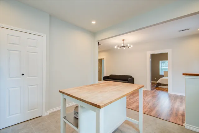 a kitchen with a stove and hallway