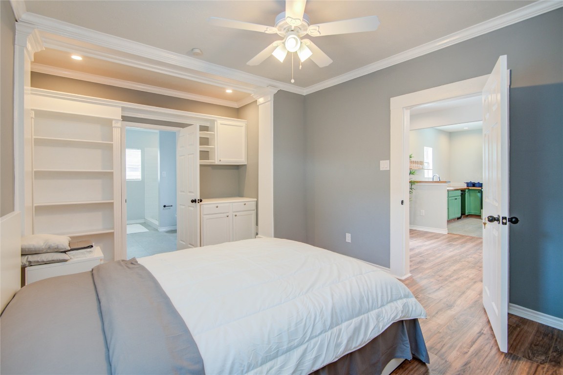2712 Link Road Houston, TX 77009 - Photo 19 of 35 a spacious bedroom with a bed and a chandelier