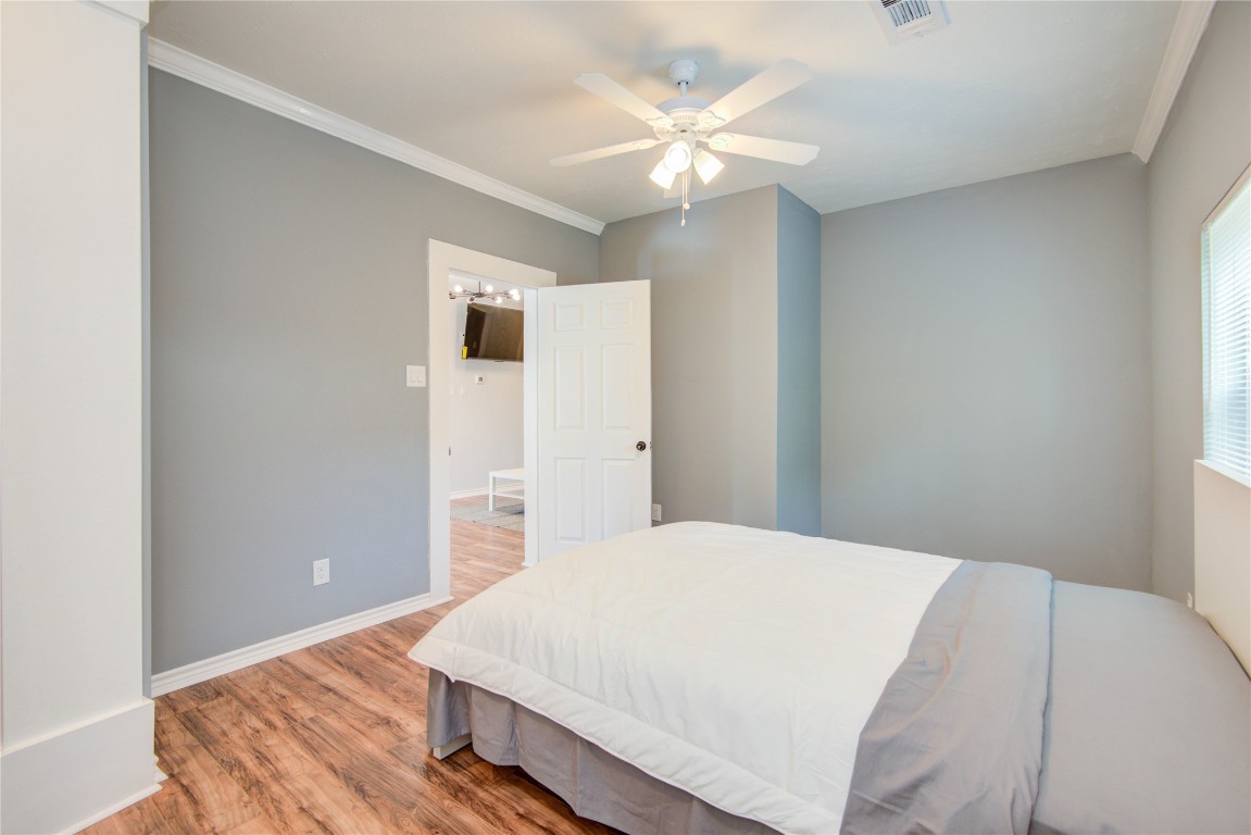 2712 Link Road Houston, TX 77009 - Photo 20 of 35 a bedroom with a bed and a chandelier