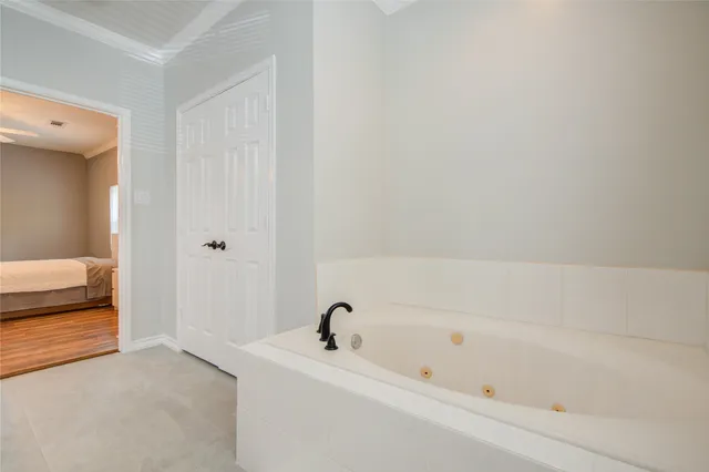a bathroom with a tub and a sink