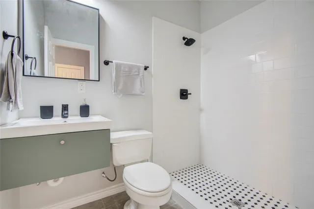 a bathroom with a toilet a sink and mirror