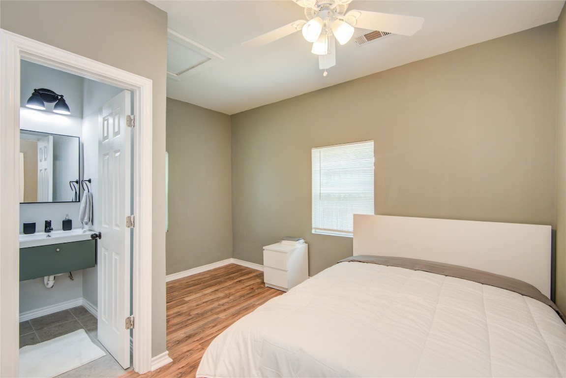 2712 Link Road Houston, TX 77009 - Photo 28 of 35 a bedroom with a bed and a chandelier