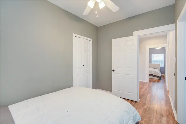 a bedroom with a bed and wooden floor