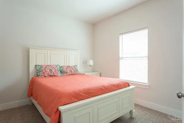 a bedroom with a bed and window