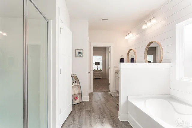 a bathroom with a bathtub sink and mirror