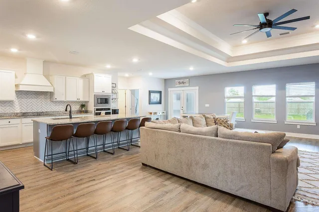 a living room with furniture and a wooden floor