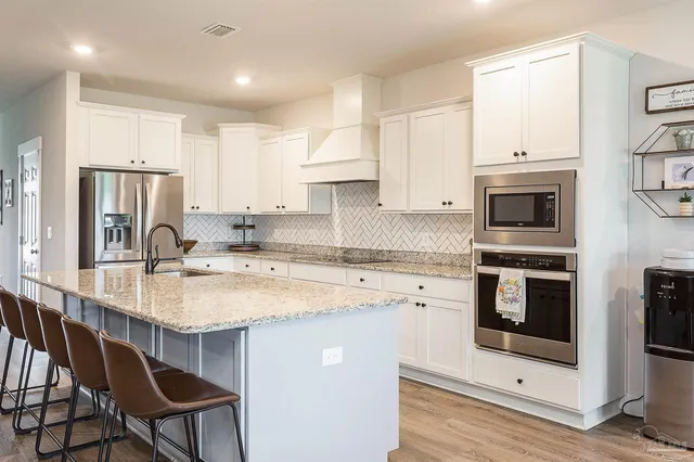 a kitchen with a stove a sink and a refrigerator