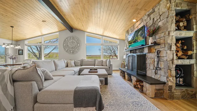 a living room with furniture a flat screen tv and a fireplace