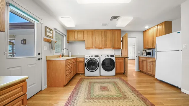 a utility room with sink a washer and dryer
