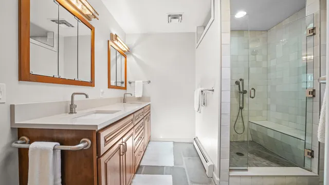 a bathroom with a sink a mirror and a shower