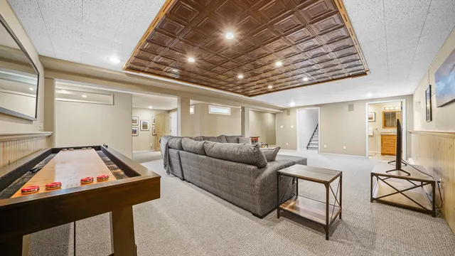 a living room with furniture and a chandelier