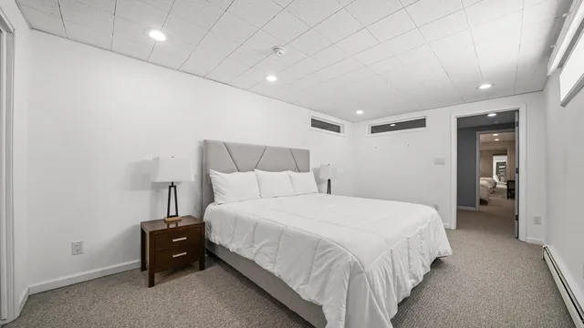 a bedroom with a bed and a lamp