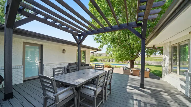 a view of a patio with a table chairs and a backyard