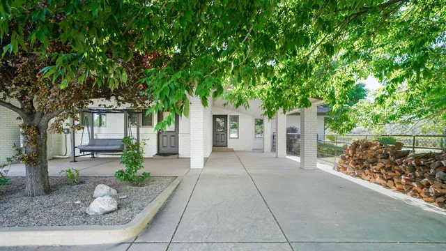 a view of a house with a tree in the background
