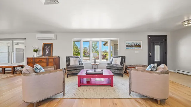 a living room with furniture and a large window