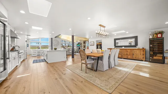 a living room with furniture a dining table and kitchen view