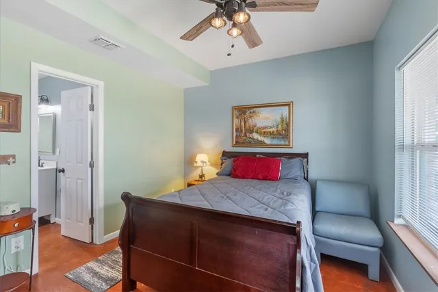 a bedroom with a bed and a couch