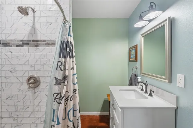 a bathroom with a sink a mirror and shower