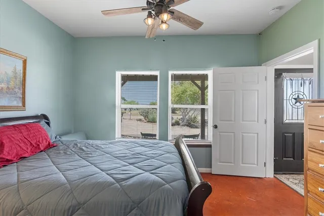 a bedroom with a large bed and a window