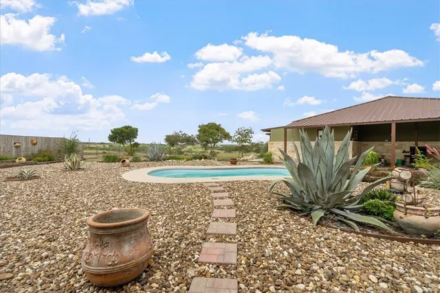 a view of a fountain in the backyard of a house