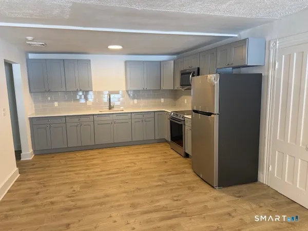 a large kitchen with cabinets and stainless steel appliances