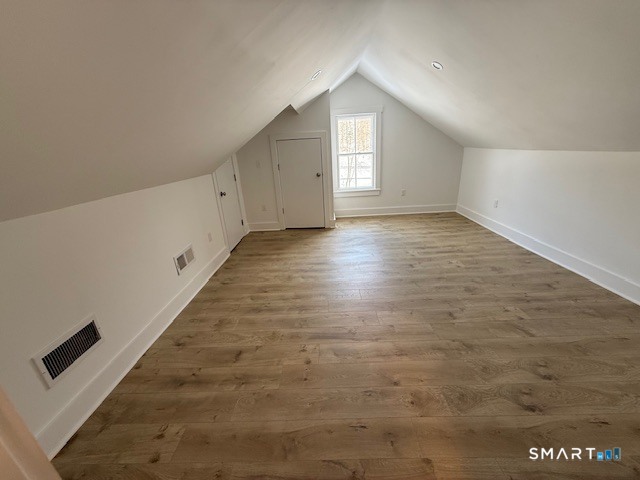 667 South Britain Road, Unit A Southbury, CT 06488 - Photo 8 of 8 an empty room with wooden floor and windows