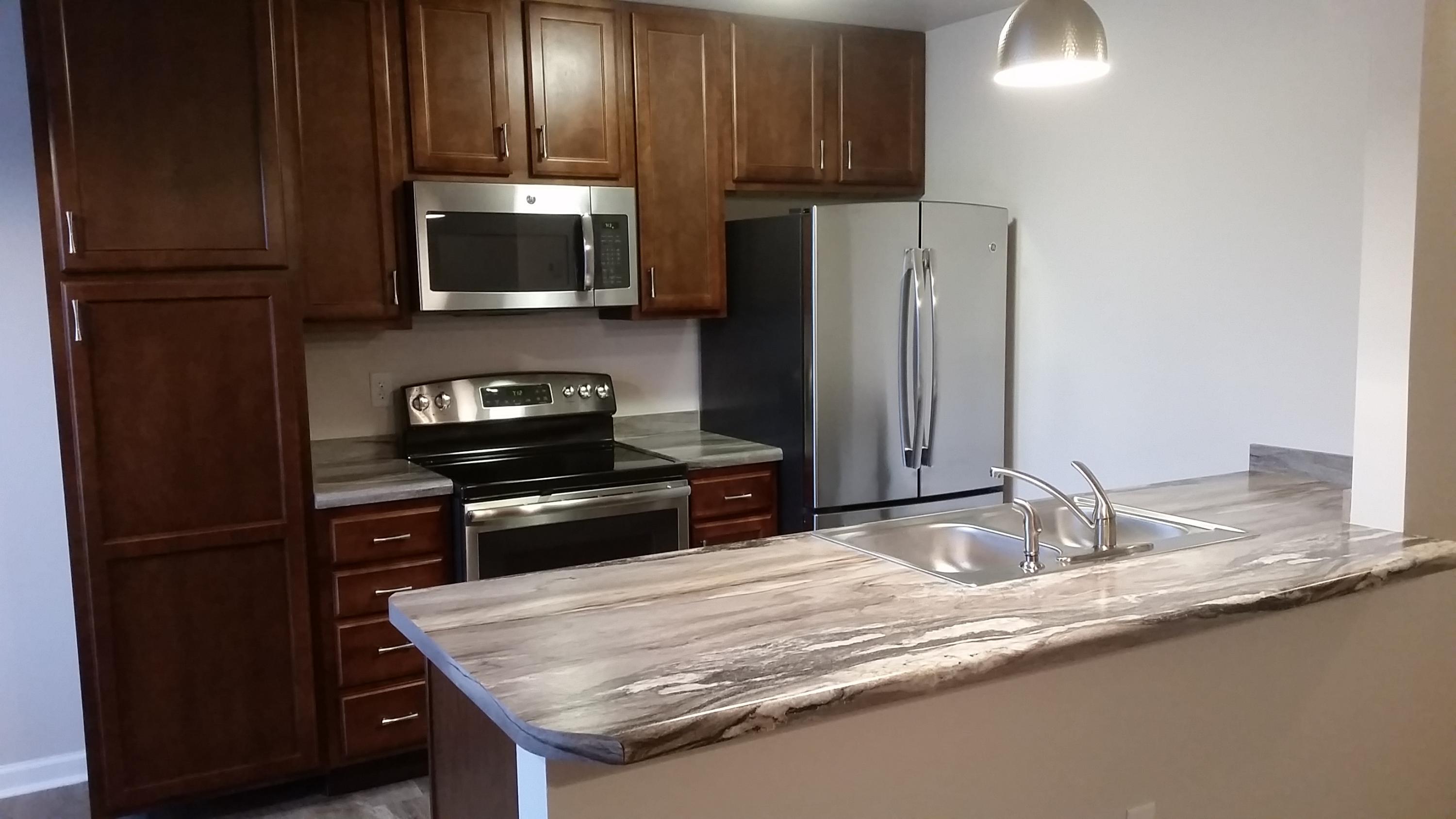 941 Valley Road, Unit C Crestview, FL 32539 - Photo 1 of 3 a kitchen with granite countertop wooden cabinets and a stainless steel appliances