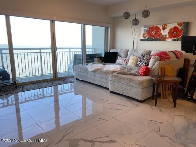1805 Riverside Drive, Unit 404 Titusville, FL 32780 - Photo 11 of 19 a living room with furniture and a large window