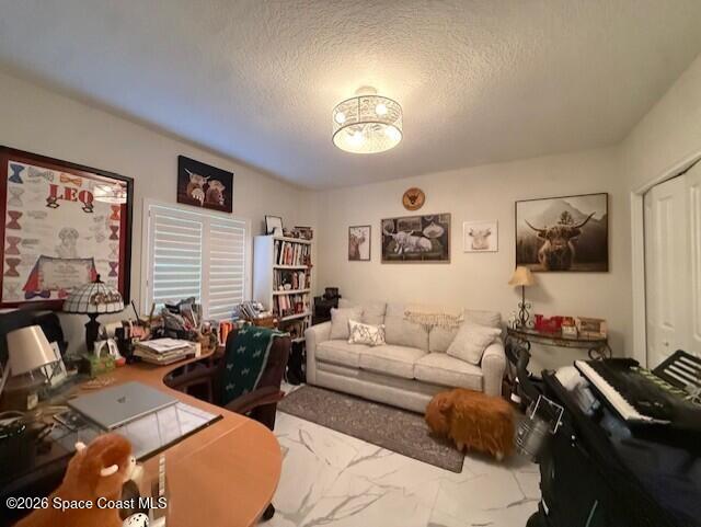 1805 Riverside Drive, Unit 404 Titusville, FL 32780 - Photo 16 of 19 a living room with furniture and a flat screen tv