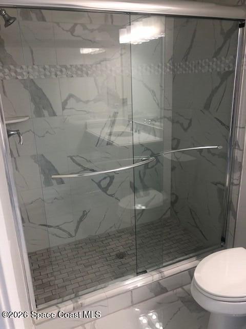 1805 Riverside Drive, Unit 404 Titusville, FL 32780 - Photo 18 of 19 a bathroom with a shower a toilet and a sink