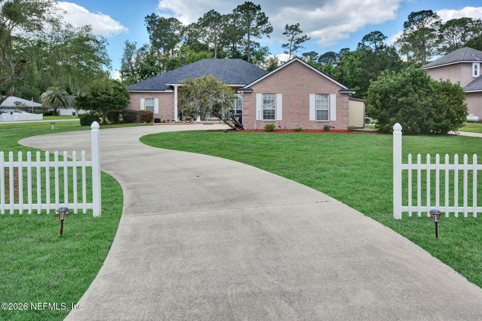 5950 West Shores Road Orange Park, FL 32003 - Photo 38 of 42 a front view of a house with a yard and green space